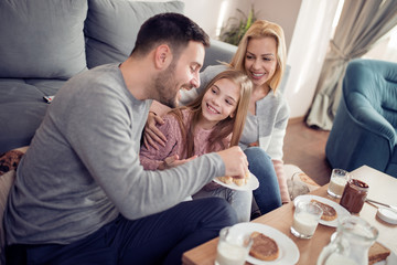 Happy family having breakfast together at home
