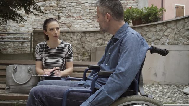Social worker meeting a man in wheelchair