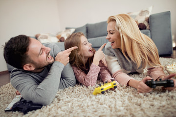 Playful family playing video games together