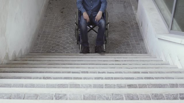 Helpless man in wheelchair and inaccessible stairs