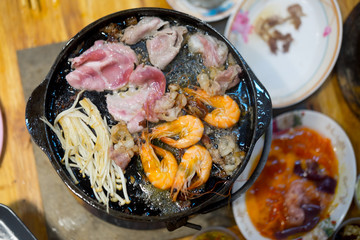 Grilled raw meat beef, pork and shrimp a food cooking in hot pan