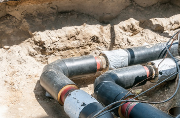 Underground district heating pipeline reparation and reconstruction on the street in the city old...