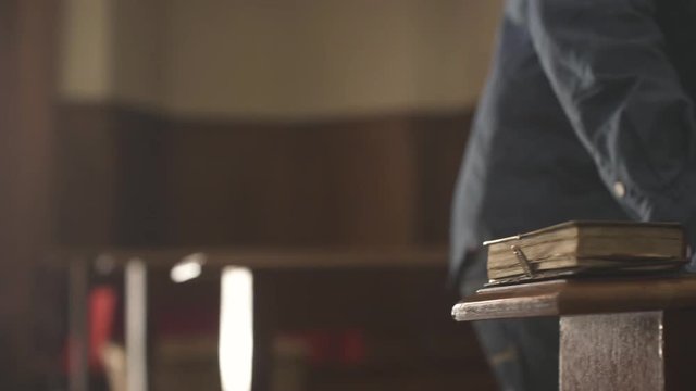 Religious man walking in the Church and kneeling