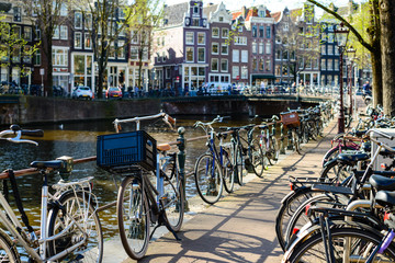Traditional dutch bicycles parked on the bridge in Amsterdam, th