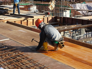 Construction workers fabricating steel reinforcement bar at the construction site. The...