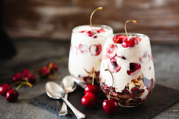 Homemade trifle pudding with freshcherry on dark background