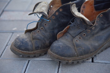 Old bad worn out dirty ragged boots shoes 