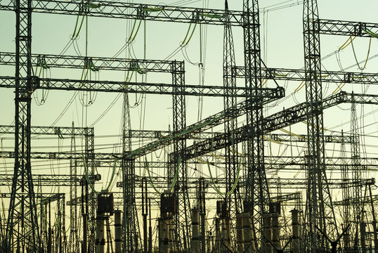 industrial background - graphical silhouettes of different structures of an electrical substation in a backlight..