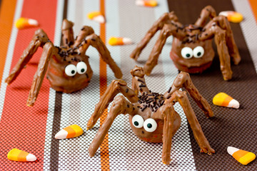 Halloween spider cakes with candy eyes in chocolate, Halloween treats for kids