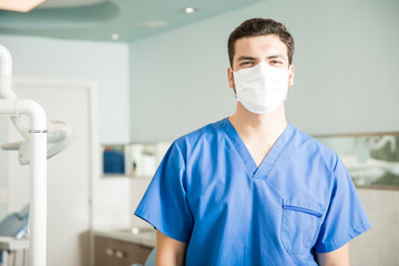 Fototapeta na wymiar Portrait Of Male Dentist Wearing Mask In Clinic
