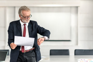 Mature CEO Businessman Checking Time to Start Conference with Business People and Partner in...