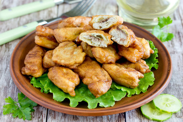 Fish in batter - deep fried battered fish pieces on plate