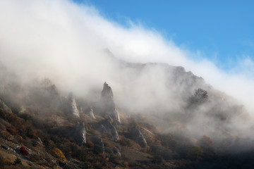 Slope mountain on a background of blue sky with clouds