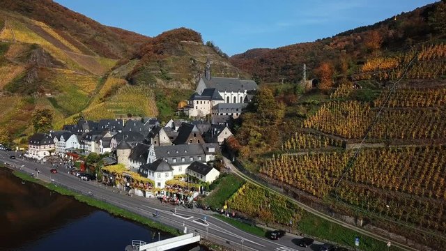 Flight over Beilstein town and autumn vineyards, Mosel valley, Germany.