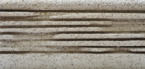 Concrete surface is broken and eroded horizontally.