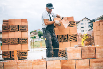 construction worker on construction site working with bricks