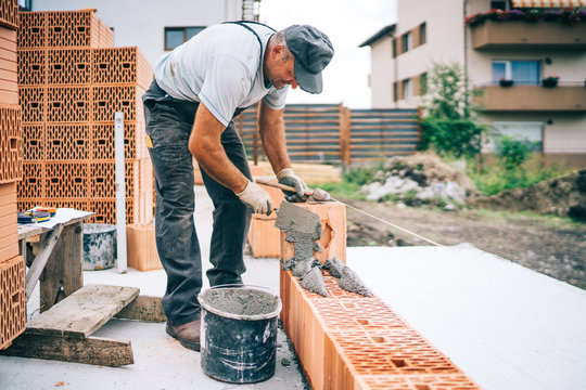 Construction industry details - Worker mason building exterior brick walls