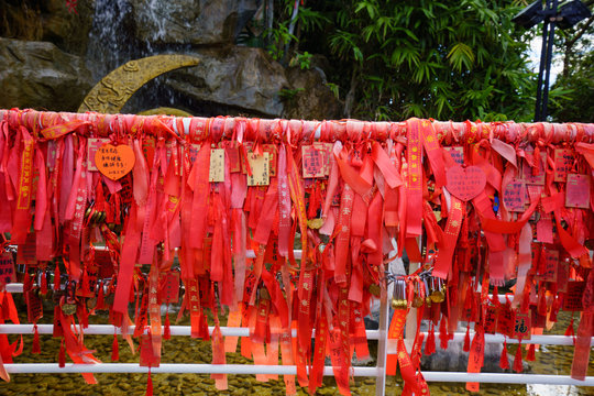 Wish ribbons on fence in park