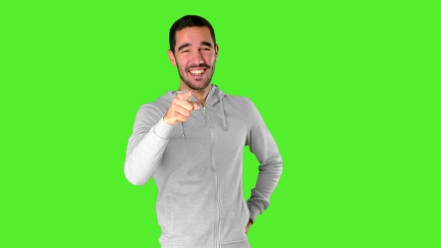 Funny young man laughing at you on chroma key