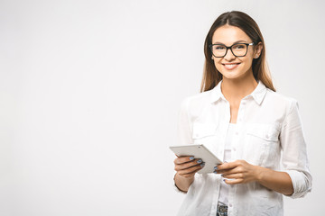 Portrait with copy space empty place of pretty charming confident trendy woman in classic shirt having tablet in hands isolated on white background