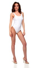 Fototapeta premium Pretty girl in white swimsuit is posing against a white background, isolated