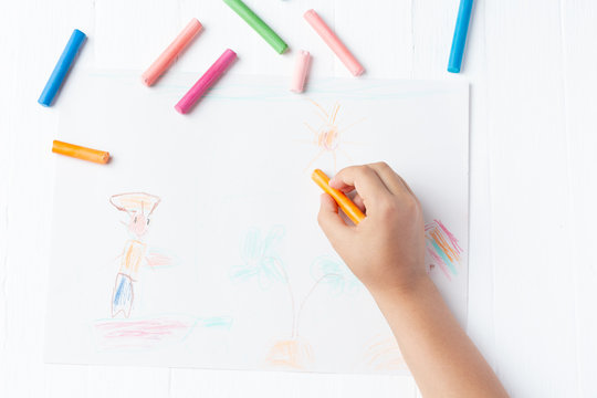 A girl draws a crayon, a pastel, a journey through the sea. Ship, sailor, boy, palm, sea
