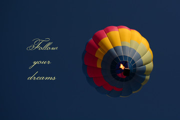 Follow your dreams concept. Hot air balloon colorful in sky
