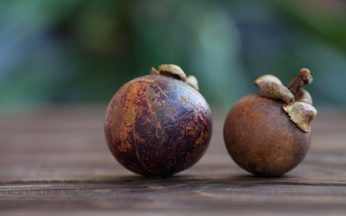 Purple mangosteen or Garcinia Mangostana, known simply as Mangosteen. Wooden background.