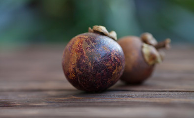 Purple mangosteen or Garcinia Mangostana, known simply as Mangosteen. Wooden background.