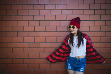 Portrait asian hipster girl on brick wall background,Lifestyle of thailand people