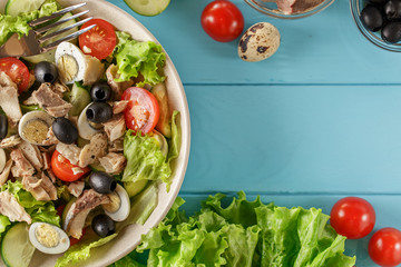 Tuna salad plate on blue wooden background.