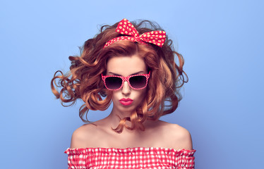PinUp Beauty Girl Blowing lips. Curly hairstyle.