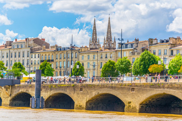 People are enjoying a sunny day on promenade alongisde Garonne river in Bordeaux, France