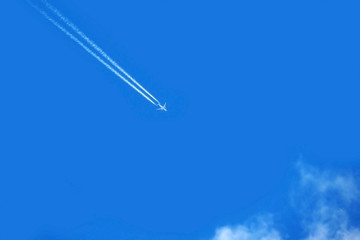 Military supersonic Russian fighter plane in the clouds. Army plane in the blue sky at high speed.