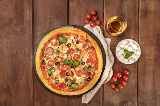 Pepperoni Pizza With White Wine, Ingredients, And Place For Text, Overhead Shot