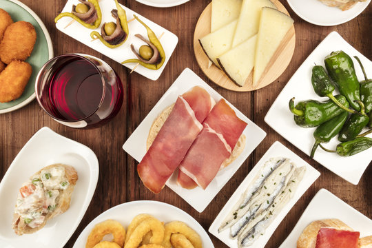 Spanish food. Overhead closeup photo of various tapas with wine