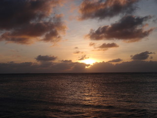 Ocean Sunset Peaking through the Clouds