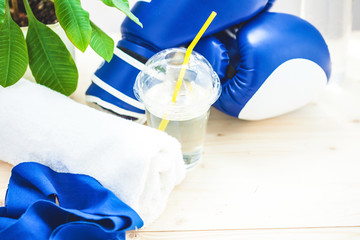 set for sports, a yoga mat, a towel, boxing gloves and a bottle of water on a light background The concept of a healthy lifestyle Close up