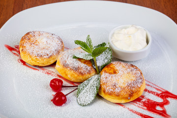 Delicious syrniki with cream