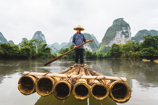 Portrait of man standing on bamboo raft in Quay Son River