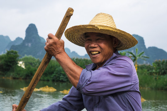Chinese man sitting on raft on Qu&acirc;y Son
