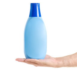 Bottle with the conditioner for linen clothes in hand on a white background isolation