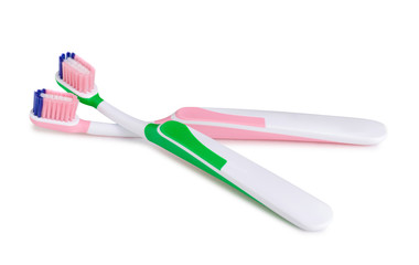 Two toothbrushes green pink on white background isolation