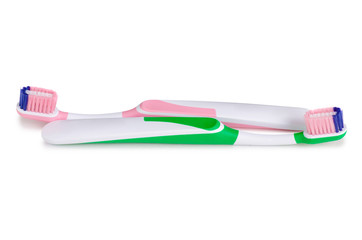 Two toothbrushes green pink on white background isolation