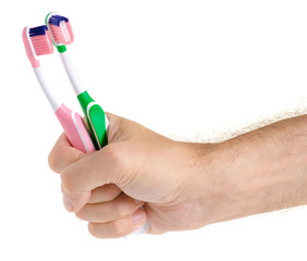 Two toothbrushes in hand on white background isolation