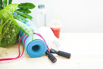 set for sports, a yoga mat, a towel, smoothies, jumping rope, a bottle of water The concept of a healthy lifestyle Copy space