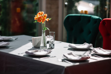 Table served for dinner with flowers on it