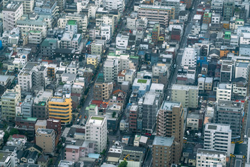 Obraz premium Aerial view of densely built City blocks seen from high angle perspective in Tokyo, Japan