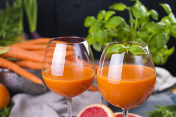 Juice from fresh carrots and grapefruit in a glass, vitamin drink for a healthy diet. Vitamins. Copy space.