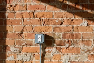 Bare Brick Electric Outlet